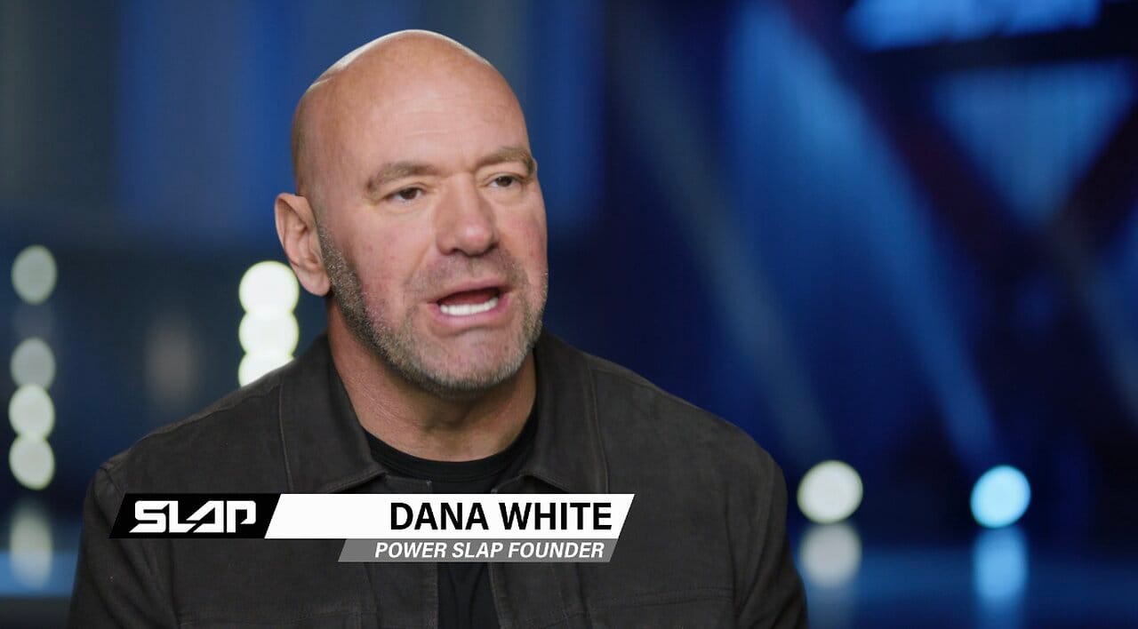 Dana White (Power Slap Founder) speaking in front of blue background.