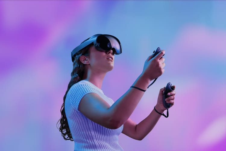 Woman using VR set with pink and blue background.