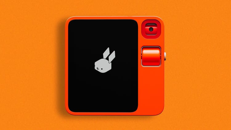 Rabbit R1 device against an orange background.