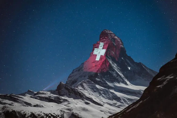 Mountain with a Swiss flag; Apple's Secret AI Swiss Lab